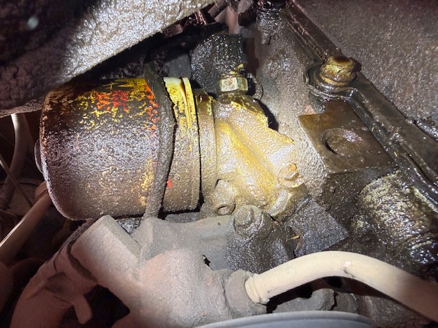 Mobile mechanic working on engine